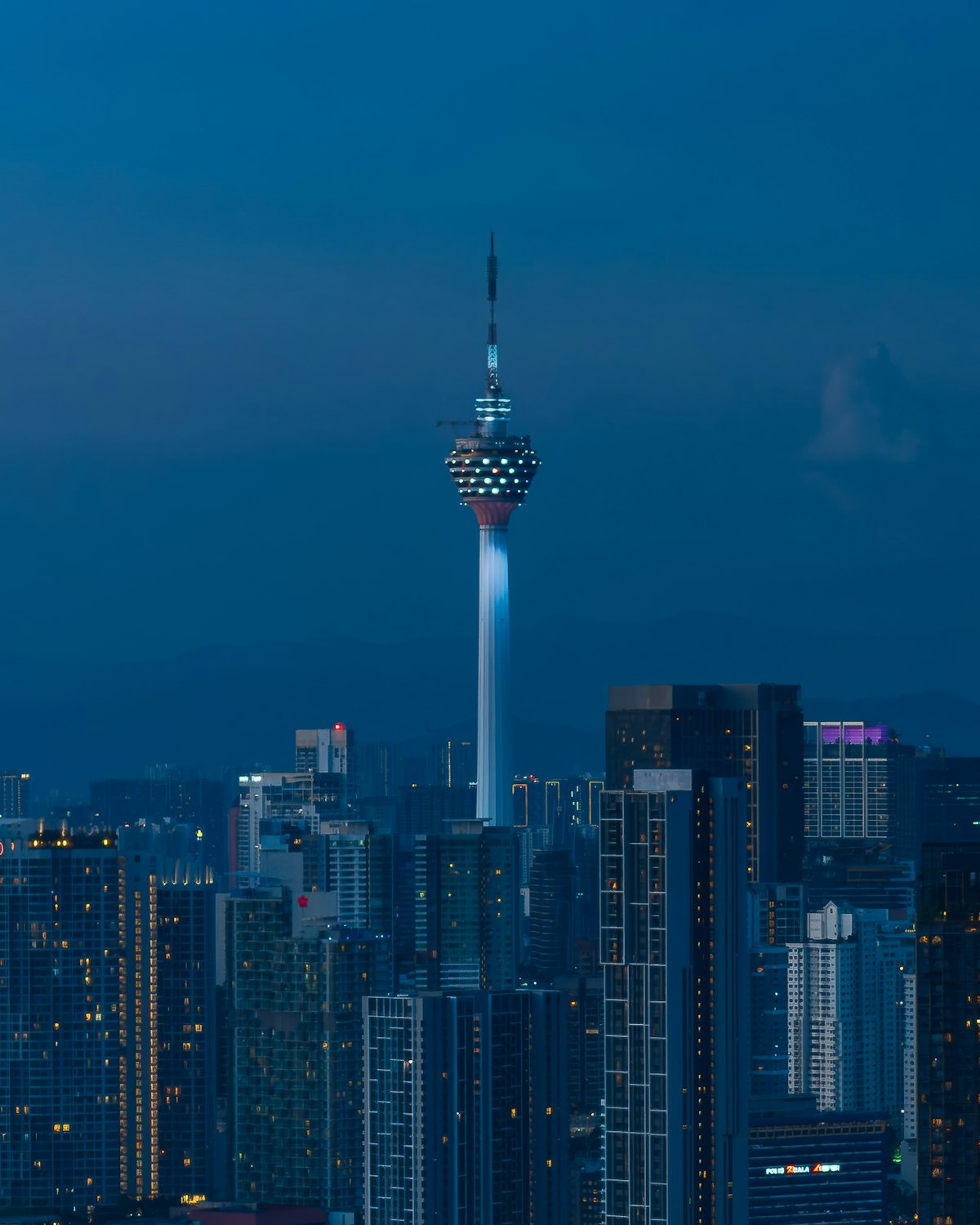 Illuminated financial-district skyscraper at dusk